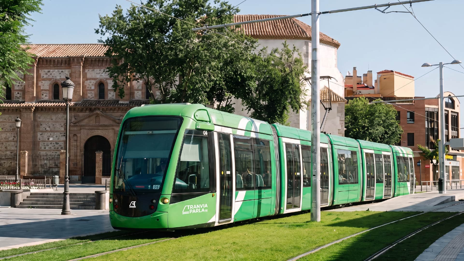 Tranvía de Parla circulating alongside the church with the new identity designed by Baud
